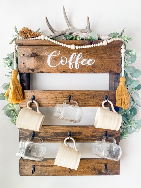 "This coffee rack is made from 100% pallet wood. It holds 9 coffee mugs. The word \"coffee\" is hand painted and designs vary. This is a great Wall conversation piece! The coffee rack is approximately 27 inches tall and  21 inches wide. Coffee rack sizes vary just a bit depending on the pallet used. Contact us with custom colors!" Coffee Rack, Wood Pallet Wine Rack, Coffee Cup Rack, Antler Projects, Painting On Pallet Wood, Blue Coffee Cups, Pallet Wine, Farmhouse Coffee Bar, Diy Coffee Bar