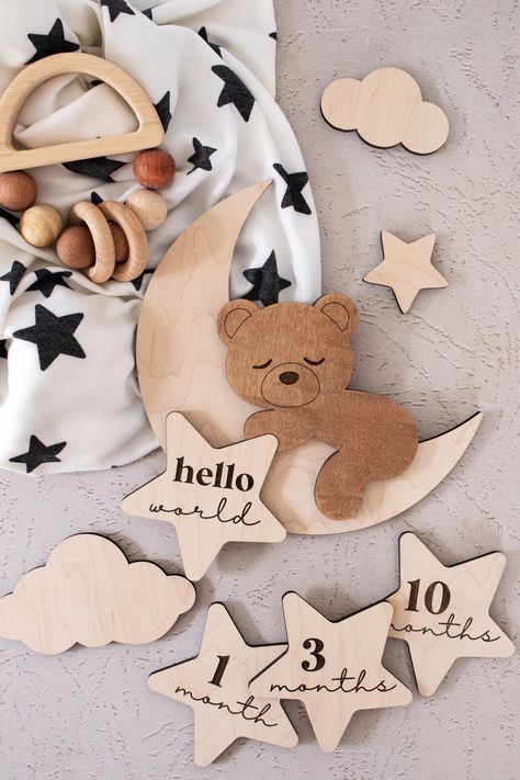 "✰ ALL options include ONE layered and engraved wood teddy bear, THREE small clouds, ONE small plain star (not engraved), ONE \"hello world\" engraved star and removeable putty to secure milestone marker/s ✰ Wood monthly milestones can be changed at any time ✰ Made from 1/4\" maple wood ✰ Laser cut  & engraved ✰ Sign is shown in raw maple ✰ The back is left unfinished on all pieces Disclosures: ✰ Please note that as wood is a natural material, each piece will have different graining, patterns and possible knots. No two items will ever be the same. Please keep small parts away from children. ✰ All products are made to order, signs can take 1 - 2 weeks, most orders are shipped within 1 week ✰ Props and clothing used in images not included Follow us on Instagram: @corinanielsen Follow us on T Laser Wood Projects, Wood Laser Cut Ideas, Laser Cut Gifts, Neutral Baby Decor, Laser Products, Cnc Machine Projects, Milestone Markers, Birth Stats Sign, Small Clouds