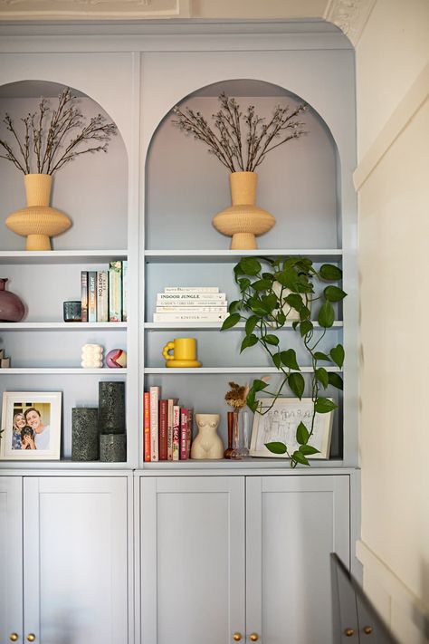 Light blue built-in bookshelf and cabinets in white living room. Small Space Built Ins Living Room, Light Blue Bookshelf, Blue Built Ins Living Room, Built Ins With Lights, Vintage Built Ins, Blue Built In Bookcase, Blue Built Ins, Light Blue Office, Builtin Bookshelves