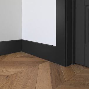 For homes and structures, Skirting Boards are both functionally and aesthetically required. They frequently cover uneven surfaces or joints and are essential in creating connections between materials in construction. Additionally, they serve as a barrier between the walls and the floor, shielding the walls from dirt, scuffs, and damage. Matt Black Skirting Board, Black Skirting Boards Bedroom, Square Skirting Board, Black Skirting Boards And Doors, Black Doors And Skirting Boards, Black Vestibule, Navy Skirting Boards, Black Skirting Boards White Walls, Black Architraves