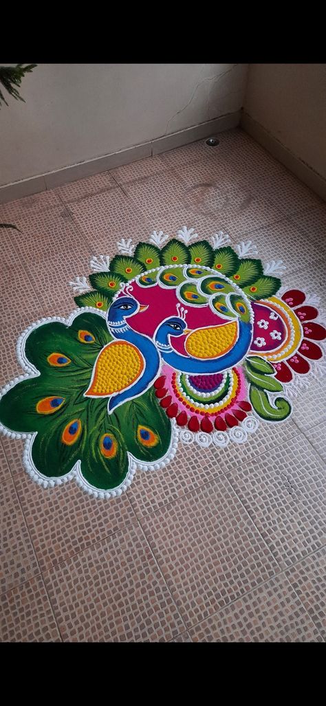 Ragoli Color Design Peacock, Unique Rangoli Designs Beautiful Peacock, Rangoli Designs For Diwali Peacock, Rangoli From Paint, Flower And Rangoli Design, Ragoli Color Design 2024 New, Trending Rangoli Design For Diwali, Peacock Rangoli With Flowers, Huge Rangoli Designs