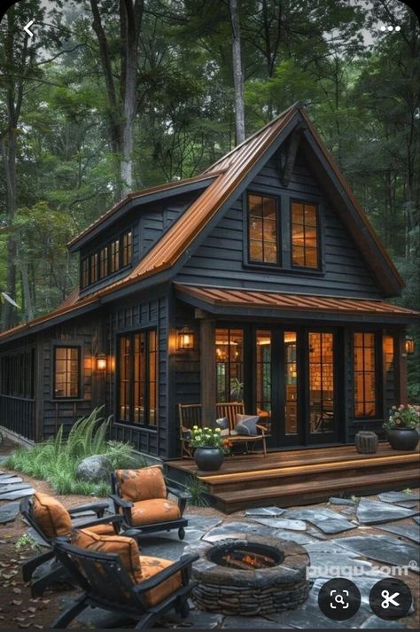 Dark Mountain House Exterior, Small Black Houses Exterior, Black House Exterior Copper Accents, Modern Woodsy Home Exterior, Green House With Wood Stove, Black And Wood Barndominium Exterior, Pnw House Interior, Cabin The Woods, Black Metal Exterior House