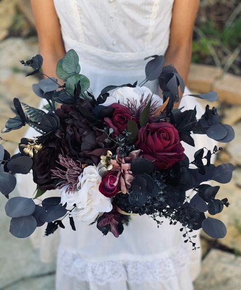 Stunning one of a kind bouquet. Featuring preserved eucalyptus and bold black, burgundy, plum purple, burgundy and white enchanting this lovely moody bouquet. Make a statement with this bouquet for your Halloween, Gothic or moody inspired wedding.  Available with ribbon or twine wrapped base.  Please note: The lovely bouquet will be created with artificial and preserved accents with the ultimate details and beauty. With anything handmade all pieces are made to be sisters and not twins so the bou Purple Burgundy Wedding Flowers, Bouquet For Black Dress, Dark Wildflower Bouquet, Burgundy And Purple Wedding, Moody Bouquet, Jewel Tone Wedding Flowers, Black Bouquet, Preserved Eucalyptus, Ankle Tattoos