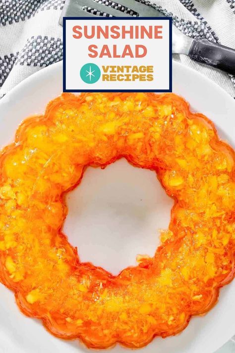 Brighten up your table with this vintage Sunshine Salad, also known as Carrot Jello Salad. This nostalgic dish combines lemon Jell-O, crushed pineapple, and freshly grated carrots for a refreshing and colorful treat. Perfect for picnics, potlucks, or as a sweet side dish, this salad brings a burst of sunshine to any meal. Get the easy recipe and find out how to make old fashioned orange carrot jello salad for dinner. Golden Glow Jello Salad, Orange Congealed Salad Recipes, Orange Pineapple Jello Salad, Orange Jello Salad With Cottage Cheese, Green Jello Salad Pineapple, Carrot Jello Salad, Lemon Jello Salad, Sunshine Salad Recipe, Mandarin Orange Jello Salad