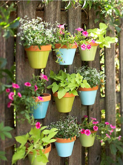 How pretty is this fence covered with suspended flowerpots? More colorful touches for outdoor decorating: http://www.bhg.com/home-improvement/porch/outdoor-rooms/colorful-backyard-decorating-ideas/ Vertical Gardens, Have Inspiration, Creative Gardening, Unique Gardens, Hanging Pots, Garden Fence, Backyard Decor, Vertical Garden, Dream Garden