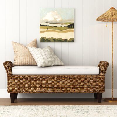 We think this wicker bench looks just as good at the end of your bed as it does sitting in the entryway. It's handcrafted with a wooden frame and features woven abaca fibers that create a breezy, coastal look. This bench has a wide apron and two short, angled sides, along with solid mahogany block feet. It comes with a foam-filled bench cushion that's wrapped in 100% polyester upholstery. This bench is just the right spot to pull your shoes on or off during the day, or keep your accent pillows o Cushioned Bench, Rattan Bench, Wicker Bench, Upholstered Dining Bench, Bali Design, Sitting Bench, Hall Ideas, Bench With Back, Rattan Cane