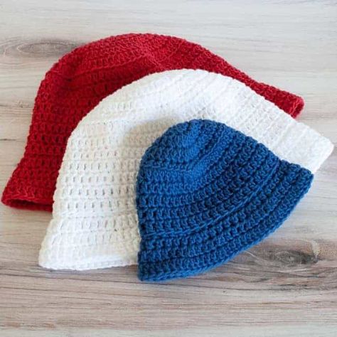 Whip up a quick crochet bucket hat with this free pattern! Grab some worsted weight yarn and make this hat that comes in eight sizes from baby to adult. Worsted weight 100% cotton like WeCrochet/KnitPicks Dishie works great for a breathable hat. Or try other fibers too. Make a bunch for the whole family in a variety of colors. This quick project can be made in an evening or a weekend. Childs Crochet Hats Free Pattern, Free Crochet Patterns For Hats For Kids, Easy Bucket Hat Pattern, Crochet Pattern For Bucket Hat, Kids Crochet Hat Patterns, Crochet Toddler Bucket Hat Free Pattern, Double Crochet Bucket Hat, Free Crochet Pattern For Bucket Hat, Baby Bucket Hat Crochet Pattern Free