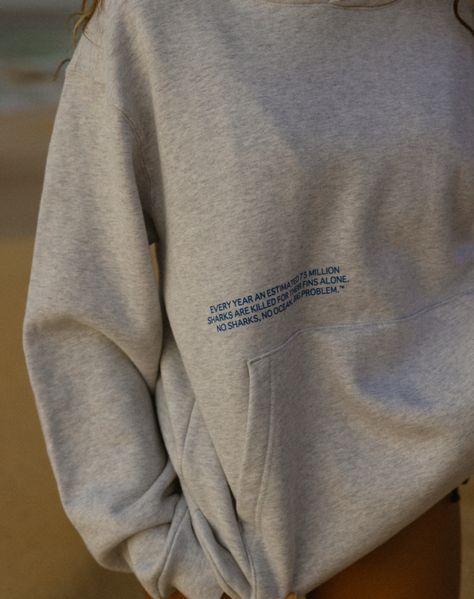 "Every year an estimated 73 million sharks are killed for their fins alone. No sharks, no ocean, big problem." ™ Our heavyweight cotton fleece hoodie. 100% organic cotton. Kangaroo pocket, ribbed cuffs & hem. Design screen printed with puff ink heart. This custom hoodie was developed to have a relaxed, oversized fit that will last years to come. Expect some shrinkage after first wash. Emilie is 5'5" wearing a size large. Sizing is unisex. Hoodies With Messages On The Back, Unisex Hoodies Design, Text Me When You Get Home Hoodie, Ocean Sweatshirt, Minimalist Hoodie, Shark Hoodie, Design Hoodie, Custom Hoodie, Streetwear Sweatshirt