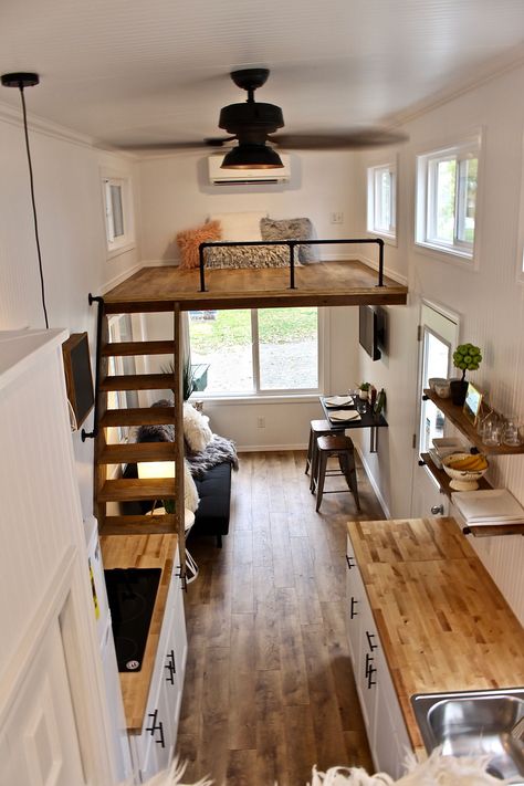 To the right of the entryway is the living room with an L-shaped IKEA sofa sleeper, IKEA fold up table, 32" flat screen TV, and ceiling fan. Above the living room is a 6.5'x7.5' bedroom loft with stairway access. Design Casa Piccola, Fold Up Table, Apartemen Studio, Wohne Im Tiny House, Asma Kat, Ikea Sofas, Casa Loft, Tiny House Interior Design, Tiny House Loft