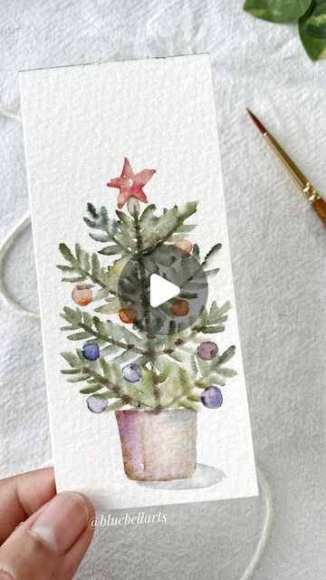 Bluebellarts by Padmini on Instagram: "Potted Christmas tree… this is all about holiday season, sparkles, delicious food! May the beauty of the season lift you up. Just watercolour and easy to paint, too 😊
Have a great weekend everyone and happy Christmas! xx 🎄 💖

Brush from Amazon and it’s Princeton Art & Brush P9143 Real Value Brush set. I mostly use the Princeton round brush size 2
Painted with watercolour @winsorandnewton 
Cold pressed 300gsm watercolour @archespapers
 
#watercolorillustration #watercolorpainting #watercolorvideotutorial 
#christmastree #mutedandmoody 
#christmastime🎄 #floralpattern #flowerdesign 
#artdaily #artreels #reelitfeelit #reels #transition #instareels #paintings #watercolorartefact #watercolorbookmarks #watercolorflowers #astheticart #artasthetics #botani Watercolor Xmas Cards Diy, Easy Watercolor Christmas Tree, Easy Christmas Watercolor Paintings, How To Paint Christmas, Christmas Watercolour Painting, Simple Christmas Watercolor Ideas, Easy Christmas Tree Painting, Christmas Tree Painting Easy, Christmas Watercolor Paintings Easy