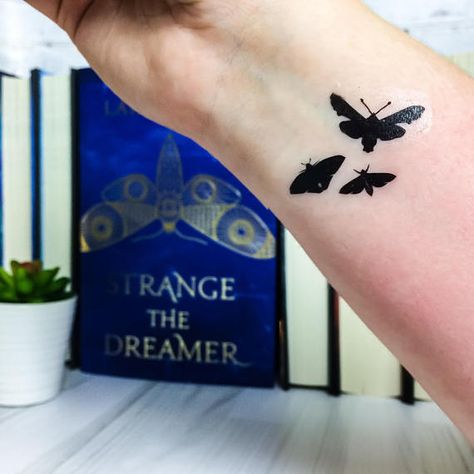 Based on the U.S. cover art of Strange the Dreamer This listing is for one Moth temporary tattoo measuring 1.75 x 1.2 Each tattoo is made to order and shape may vary slightly from the original. For best results, trim around the area of the tattoo as closely as possible to remove Dreamer Tattoo, Strange The Dreamer, Book Tattoos, Middle Grade Books, Book Tattoo, Grade Book, Beautiful Tattoos, Temporary Tattoos, Temporary Tattoo