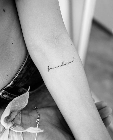 #tattoo #tattooideas #tattooart #tattoodesigns #tattoosforwomen #freedom #smalltattoos #ink #blackandwhite #smalltattooideas #wordtattoos #meaningfultattoos #armtattoo Small Tattoos Freedom, Small Freedom Tattoos For Women, Freedom Small Tattoo, Cursive Small Tattoo, Tattoo Means Freedom, Tattoo Freedom Ideas, Tattoos About Freedom, Kindness Tattoo Ideas, Freedom Tattoo Ideas