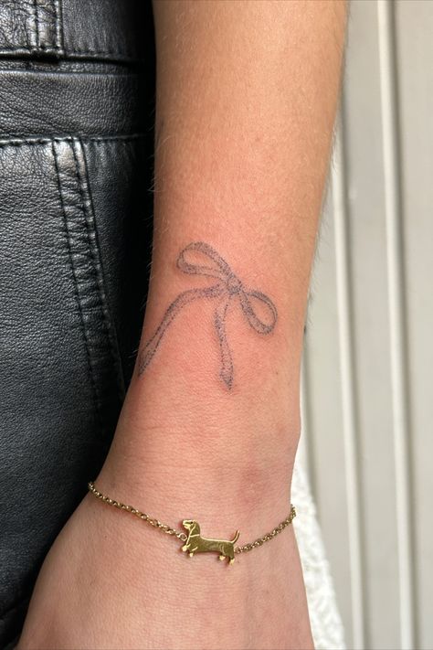 handpoked small wrist tattoo light inspo gold bracelet simple Bow On Wrist Tattoo, Wrist Bow Tattoo, Ribbon Wrist Tattoo, Artsy Tattoo Ideas, Ribbon Bow Tattoo, Bow Tattoo Designs, Earthy Tattoos, Artsy Tattoos, Bestie Tattoo