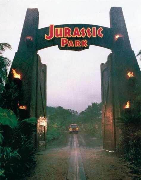 Jurassic Park is a safari amusement park created by InGen on Isla Nublar, a remote island about 120 miles (190 km) off the west coast of Costa Rica. InGen recreated Dinosaurs and other extinct animals and exposed them in a safari park to the public, where people ride in jeeps and drive by different cages with dinosaurs to encounter. The dinosaurs were cloned in special facilities on nearby Isla Sorna and brought to the park. The park was planned to be opened in 1994. Jurassic Park Gate, Jurassic Movies, Jurassic Park Series, Jurassic Park Party, Jurassic Park Movie, Jurrasic Park, The Lost World, World Party, Safari Park