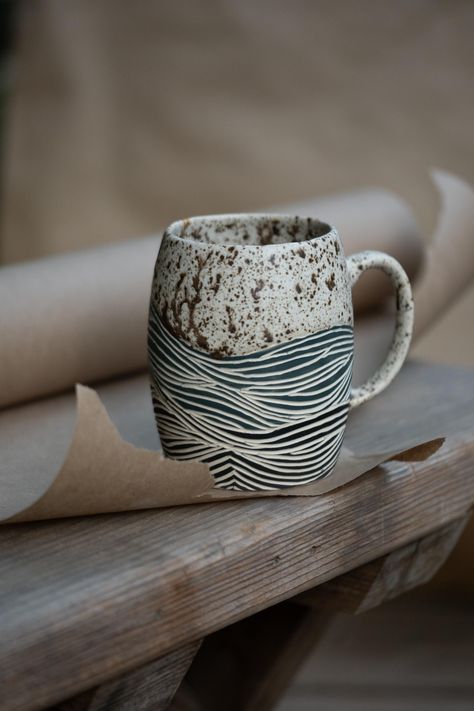 Handmade, love-filled porcelain mugs with sgraffito designs. These cups are carved with wave designs, and finished with a beautifully soft, semi-matte yet still slightly glossy glaze. This glaze has a speckled & earthy look and feels comfortable to the touch. The wave carvings are left unglazed, to preserve their raw and earthy feeling. Mug Sgraffito, Scraffito Mug, Carved Ceramic Bowls, Scrafito Designs, Sgraffito Mug, Sgrafitto Ceramics, Ceramics Carving, Ceramic Jugs Pottery, Carving Ceramics