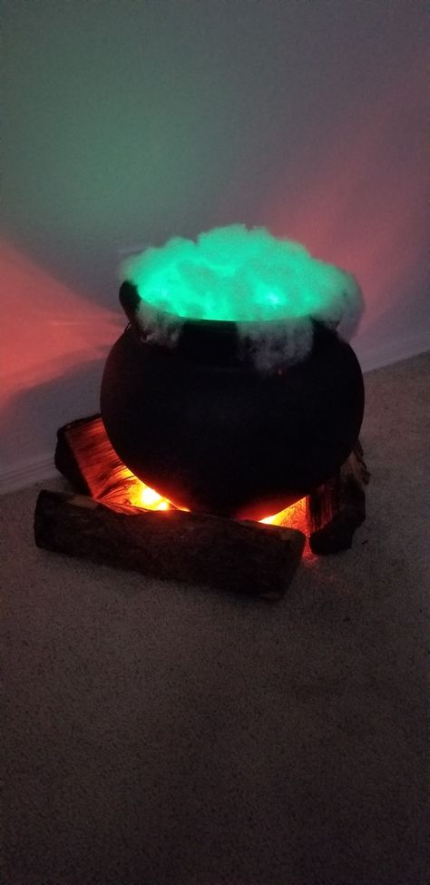 This witch cauldron is SO easy to make. I painted a flower pot black, added green LED lights (regular ones get too hot!) and ripped open a pillow for the batting. Three logs and some orange LED lights inside them. My photo of my actual cauldron. Not a found photo... Halloween Decorations Indoor Scary, Halloween House Party Decorations, Halloween Lighting, Cheap Diy Halloween Decorations, Witch Cauldron, Lights Ideas, Halloween Tutorial, Halloween House Party, Halloween Decorations Diy Outdoor