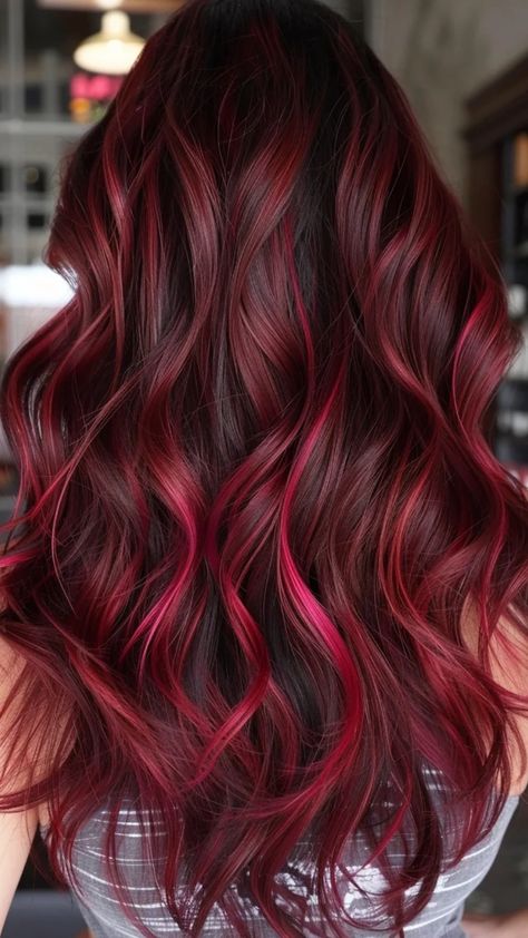 Wavy dark hair with vibrant red highlights cascading down. Cherry Highlights On Black Hair, Red And Brown Hair Color, Red Highlights In Black Hair, Cherry Red Highlights, Highlights In Black Hair, Cherry Highlights, Red And Brown Hair, Bright Red Hair Color, Copper Balayage Brunette