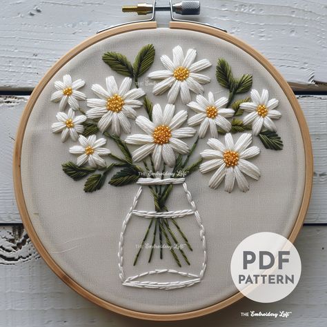 DESCRIPTION Add a touch of whimsy to your embroidery projects with this charming Vase of White Daisies hand embroidery pattern! Perfect for flower lovers and embroidery enthusiasts. Get your hoop ready and let's stitch up some floral magic with this delightful embroidery project! Happy stitching! This listing is for a digital PDF pattern, which includes: ~ Printable pattern scaled to fit 3" to 8" hoops ~ Beginner's Guide to Hand Embroidery ~ Reference photo of completed embroidery for inspiratio Flower Designs Embroidery, Embroidery Large Flowers, Back Stitch Motif, Embroidery Daisy Patterns, White Flowers Embroidery, Free Embroidery Patterns For Beginners, Hand Embroidery Flowers Pattern, Embroidery Flowers Designs, Daisy Embroidery Pattern