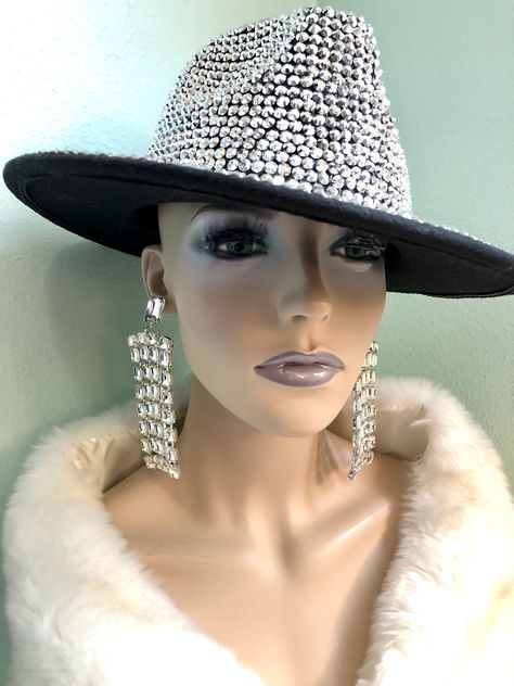 Flashy all over gem colorful hat in fedora style. Stiff and sturdy design.  Measures 22.5" in circumference Colors: Black Silver AB Purple AB Red AB Green *Please note this is for hat only, does not include earrings or faux fur shawl. Dressy Hat Outfits, Fedora Hat Outfit Black Women, Fedora Outfit, Fedora Hat Outfits, Dance Jazz, Stylish Womens Hats, Fedora Style, Classy Hats, Black Fedora Hat