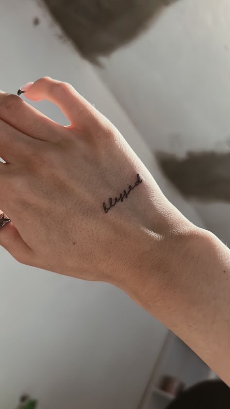 Tattoo On Hand Wrist, Hand Tattoos Quotes Words, Hand Tattoo Name For Women, Hand Qoute Tattoo, Small Hand Tattoos For Women Words, Behind The Ear Tattoo Ideas Letter, Text On Hand Tattoo, Divine Hand Tattoo, Name On Finger Tattoos For Women