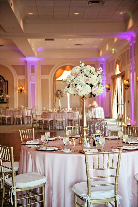 Tall White Hydrangea and Blush Pink Rose Centerpiece Flowers in Gold Vase with Pink Specialty Linens and Gold Chiavari Chairs | Wedding Reception Decor #ChairWedding Chiavari Chairs Wedding, Navy Wedding Theme, Wedding Reception Head Table, Wedding Table Pink, Reception Head Table, Wedding Reception Chairs, Gold Chiavari Chairs, Wedding Table Linens, Wedding Reception Flowers