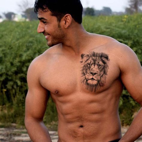 Wearing a lion tattoo can mean a lot of different things. It might show bravery or remind you to be strong in challenging situations. Lions also stand for leadership and power, just like in the wild. People might choose a lion tattoo to feel more confident or to remember they dare to face their fears, just like the mig Lion Chest Tattoo Men, Lion Tattoo Chest, Lion Tattoo Men, Lion Face Tattoo, Scratch Tattoo, Lion Chest Tattoo, Lion Shoulder Tattoo, Owl Tattoo Drawings, Tattoo Lion