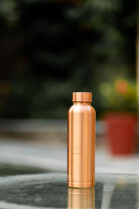 Introducing the KOSMOH Premium Copper Water Bottle: a masterpiece crafted with passion by our artisans, embodying the timeless beauty of copper while ensuring enduring quality. Keep Water Cool: Experience the refreshing difference as your water stays cool for longer periods, enhancing your hydration experience, especially after invigorating yoga and meditation sessions. Therapeutic Properties: Our Copper Water Bottle infuses your water with trace amounts of copper, known for its potential to aid digestion, boost immunity, and promote radiant skin, offering holistic well-being benefits. Encourages Balance: Align yourself with the innate energy of original copper, fostering a deeper connection with your inner self in the realm of yoga and meditation. It's more than a bottle; it's a companion Yoga Health Benefits, Copper Bottle, Copper Properties, Copper Water Bottle, Ayurveda Yoga, Copper Candle, Food Photoshoot, Boost Immunity, Daily Rituals