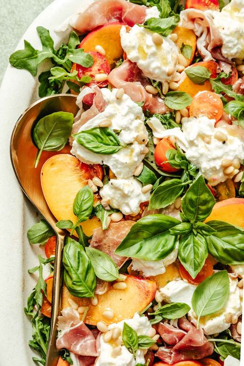 This tomato peach burrata salad recipe features a combination of creamy burrata cheese, sweet peaches, spicy arugula, spinach, tomatoes, fresh herbs, pine nuts, and sliced prosciutto. Plus, a honey Dijon dressing that’s out of this world! Burrata Salad Recipe, Peach Burrata Salad, Peach Burrata, Honey Dijon Dressing, Dijon Dressing, Burrata Salad, Burrata Cheese, Honey Dijon, Peach Salad