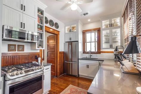 White kitchen with wood trim, white cabinets, and wood floors Kitchen With Wood Trim, Kitchen Wood Trim, White Cupboards Kitchen, Kitchen Cabinets Wood, Renovated Craftsman, Cupboards Kitchen, White Cupboards, Craftsman Cottage, Galveston Texas