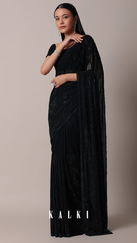 Up the glamous quotient at the upcoming cocktail party by donning this bold black saree. Adorned with all-over sparkly Swarovski embellishments, it is crafted from opulent georgette fabric. Completed with an unstitched blouse piece, this drape is an ideal pick for casual and formal occasions. Embellished Black Pre-draped Saree For Party, Party Wear Embellished Black Pre-draped Saree, Celebration Black Cutdana Saree, Glamorous Black Embellished Pre-draped Saree, Black Pre-draped Sequined Saree, Sari India, Yumna Zaidi, Kalki Fashion, Black Saree