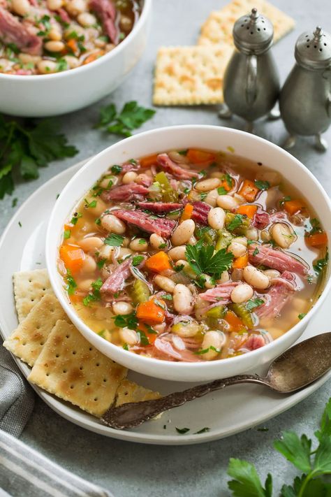 Ham and Bean Soup - a homestyle, hearty and delicious soup that couldn't be easier to make! It requires minimal ingredients including a leftover ham bone, dry beans, some veggies, herbs and broth and the slow cooker does just about all of the work. #ham #bean #soup #dinner #slowcooker #crockpot #easydinner #dinnerideas #fromscratch #homemade #crockpotsoup Ham Bone Recipes, Ham Hock Soup, White Beans And Ham, Vegetable Soup Crock Pot, Greens Soup, Ham Soup Recipes, Ham And Bean, Slow Cooker Ham, Bean Soup Recipe