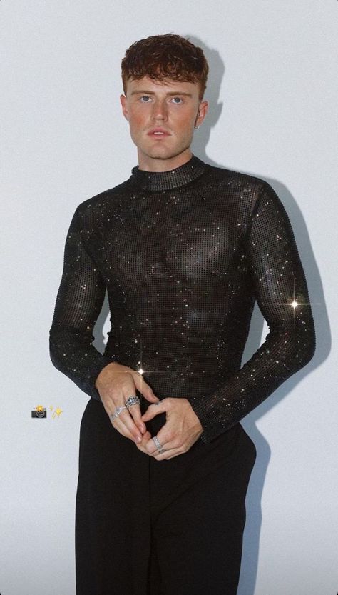 Photo of Joshua Johnston showcasing daring queer fashion: rhinestone see-through shirt, black pants, fiery ginger and curly hair—an electrifying and iconic expression of style. Curly Ginger Hair, Curly Ginger, Chicos Fashion, Rhinestone Outfit, Sparkle Outfit, Gender Fluid Fashion, High Fashion Men, Fiesta Outfit, Glam Outfit