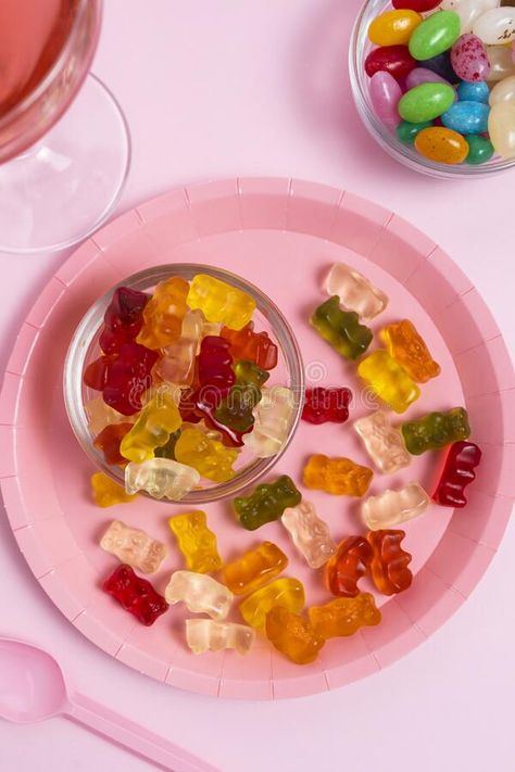 Plate with gummy bears, jelly beans and a glass with a pink drink on a pink table. royalty free stock photography Jelly Bears, Pink Drink, Celebration Background, Pink Table, Pink Drinks, Stock Photography Free, Gummy Bears, Jelly Beans, Celebration Party