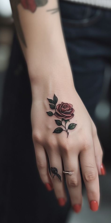 A lovely petite rose hand tattoo, featuring detailed shading and fine lines, exuding grace and elegance. This delicate design embodies love, passion, and beauty, making it an ideal choice for those seeking a meaningful and artistic representation of their individuality and emotions on their hand. Small Red Rose Tattoo, Rose Hand Tattoos, Bud Tattoo, Rose Bud Tattoo, Cover Up Tattoos For Women, Simple Rose Tattoo, Rose Hand Tattoo, Rose Tattoos For Women, Blue Rose Tattoos