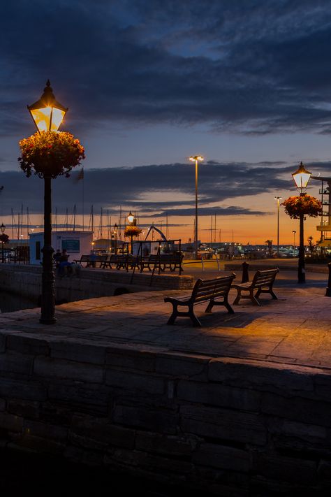 Poole Quay at dusk with orange and blue/black skies Poole Dorset, Cosy Season, The Sound Of Waves, Fall Getaways, Tourism Website, Evening Walk, Autumn Drives, End Of Days, Crashing Waves