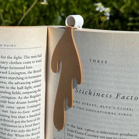 PRICES MAY VARY. ✔ Charming and Unique Design: The Spilled Coffee Bookmark features a cute and humorous design of spilled coffee on a page corner, adding a touch of whimsy to your reading routine. It's a conversation starter and a fun accessory for any book lover. ✔ High-Quality Materials: Crafted with durable materials, this bookmark is built to last through many reading sessions. The high-quality construction ensures that it securely holds your place in any book without adding bulk or weight. Book Lover Crafts Diy, Book Reading Accessories, Book Lovers Crafts, Cute Bookmark Ideas, Bookmark Design Ideas, 3d Bookmarks, Library Fundraiser, Coffee Bookmark, Coffee Gift Ideas