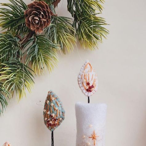 Sanita Pretkalnina on Instagram: "✨Christmas ornaments are out!✨ 🕯Each felt candle ornament is stitched completely by hand and is made from felt, beads and embroidery thread. 🕯Candle ornaments are available in 4 designs: Tender/ Classical/ Snowy/ Romantic. 🕯There are 3 options to choose from: 1. A single S size candle 2. Single, personalised L size candle 3. Personalised set ( S size candle + L size candle with personalised letter) 🕯S size candle approx. length: 3.9”/ 10cm L size candle appr Wet Felt And Bottle Lights, Felt Candle Wraps, Felt Candle Ornament, Candle Embroidery, Felt Candle Mats, Family Christmas Tree, Candle Ornament, Felt Beads, Instagram Christmas