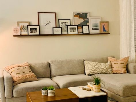 Floating Shelf Photo Gallery, Floating Shelf With Picture Frames, Floating Shelf Over Sectional, Floating Shelf Picture Wall, Long Floating Shelf With Pictures, Long Floating Shelf Above Couch, Gallery Shelf Ideas, Floating Picture Shelf Above Couch, Above Couch Floating Shelves