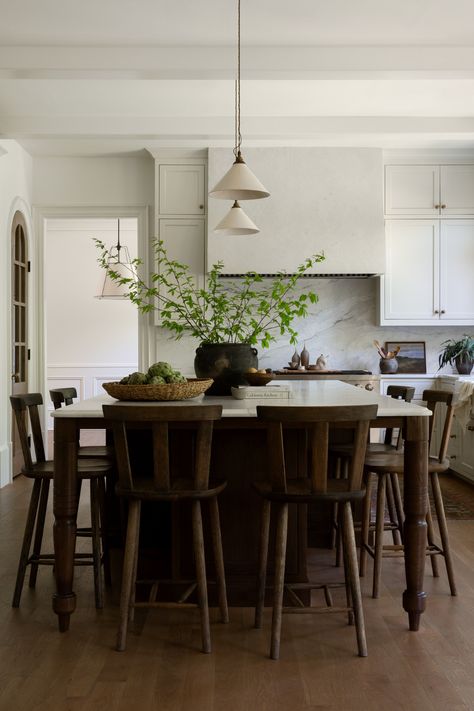 Light filled European inspired kitchen renovation with large kitchen island and pendant lighting in Roswell, Georgia by Prescott Design Dining Table As Island In Kitchen, Table As Island In Kitchen, Light And Dwell Kitchen, Large Island Decor, Transitional House Decor, Large Kitchen Island Decor, Dark Brown Island, Kitchen Island Lights Pendant, Pendent Lighting Over Island