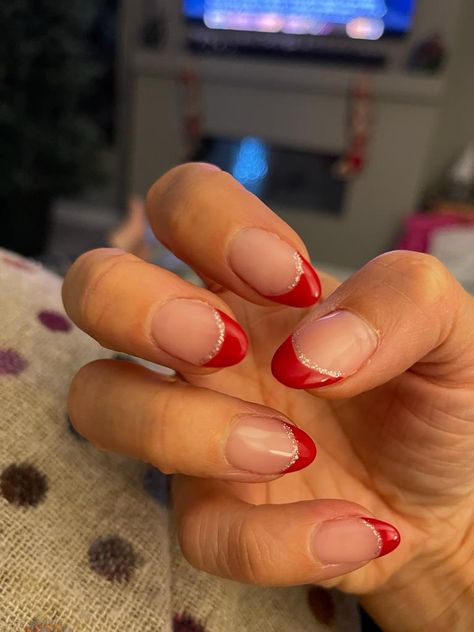 Short Almond French Tip Nails Christmas, Easy Christmas French Tip Nails, Cute Almond Nails Winter, Hoco Nails For A Red Dress, Red French Holiday Nails, Short Tip Christmas Nails, Christmas Nails Simple Design, Red French Tip With Glitter Line, Simply Christmas Nail Designs