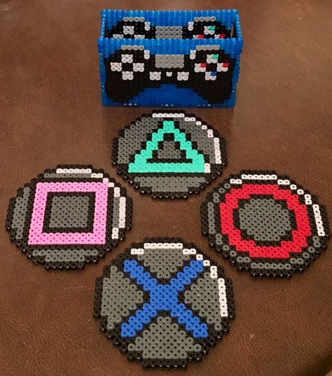 Gamers out there will be fans of Jason‏'s Playstation controller coasters to rest his cup of tea while he's video-gaming or Hama-Beading! (Twitter: @Daywalker73) Playstation Perler Beads, Perler Beads Gaming, Pyssla Coaster, Peeler Bead Coaster, Hama Bead Coasters Ideas, Gamer Perler Beads, Perler Beads Video Games, Perler Bead Games, Video Game Perler Bead Patterns