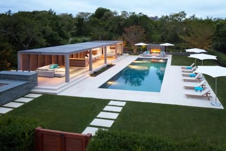 All the elements of an outdoor retreat, this poolside patio has a place for sun, shade, warmth on a cool night, and a spot to share meals with family and friends. Modern Pool Pergola, Pool Pergola, Modern Pool House, Pool House Designs, Modern Pool, Best Modern House Design, Modern Pergola, Pool Cabana, Outdoor Remodel