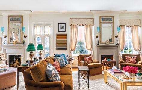 A double parlor in size, the living room’s camel-colored sofa and club chairs, all made by DFM, wear Holland & Sherry mohair velvet. A striped James Betts painting holds its own among pairs of mirrors made from architectural panels, blue Anglo-Indian sconces and antique Coalport vases-turned-lamps from Seventh Heaven Antiques. The rug is by Stark. Double Parlor Living Room, Mohair Sofa, Double Parlor, Parlor Living Room, Colored Sofa, Savannah Style, Villa Lagoon Tile, Sleek Coffee Table, Cinder Block Walls