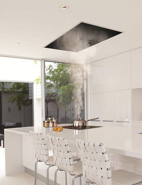 The recessed kitchen vent: Siemens ceiling hood | Corian model kitchen | Remodelista Vent Hood Over Island With Pendant Lights, Island Exhaust Hood, Modern Kitchen Range Hood, Kitchen Vents, Kitchen Island Range, Modern Refrigerator, Miele Kitchen, Ceiling Hood, Island With Stove