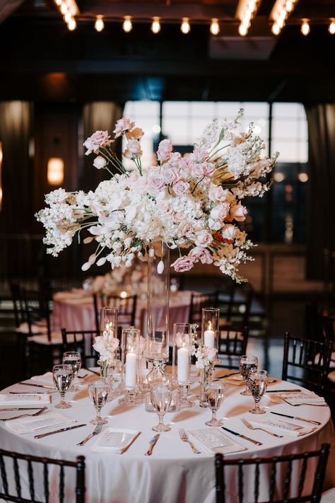 A round reception table with a tall floral arrangement of white and blush florals. Blush Pink And Black Wedding Theme, Black White Blush Wedding, Blush Pink And Black Wedding, Black Wedding Table, Pink And Black Wedding, Blush Wedding Theme, Family Style Table, Blush Wedding Colors, Romantic Ceremony