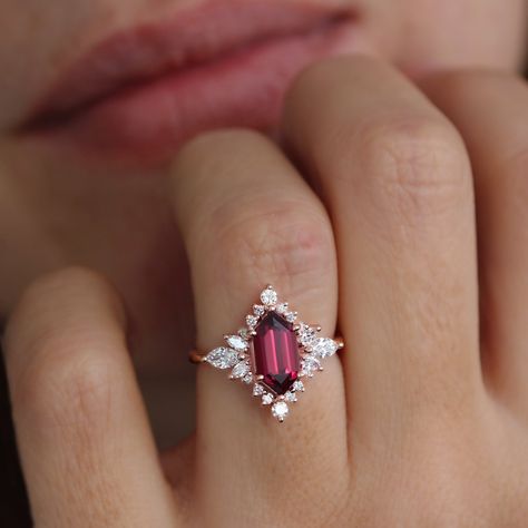 Long Hexagon Rhodolite and diamond halo Celestial Star engagement ring - Nora. D E T A I L S : ♥ Center stone shape: Elongated Hexagon  ♥ Center stone type: Rhodolite 2 carat. ♥ Accent stones: Natural diamonds, conflict-free, 0.70ct, F color, VS clarity. ♥ Gold: 14K or 18K solid gold. Yellow, white, or rose gold. ♥ Sizes: 4 - 11. Please select your wanted ring size and gold color in the drop-down menu. ♥️♥️♥️ Service ♥️ Free IGL Jewelry Certificates: including evaluation for insurance; the certi Opal Garnet Ring, Unique Wedding Rings Ruby, Ruby Halo Engagement Ring, Engagement Rings Different Stones, Diamond And Garnet Engagement Ring, Diamond And Amethyst Engagement Ring, Acotar Engagement Ring, Hexagonal Engagement Ring, Star Engagement Ring