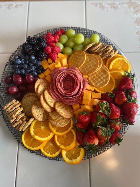 Charcuterie board surrounded with grapes, circular orange slices, blueberries, blackberries, strawberries, raspberries, mild cheddar cheese cubes, a different variety of crackers  and a salami rose. All on a circular platter. Salami Cheese Fruit Platter, Cheese Board With Fruit, Fruit Cheese Cracker Platter, Cute Easy Charcuterie Board, Cracker Cheese Board, Chacudory Board, Charcoochie Board Ideas, Fruit And Cracker Charcuterie Board, Cachutery Board Ideas Small