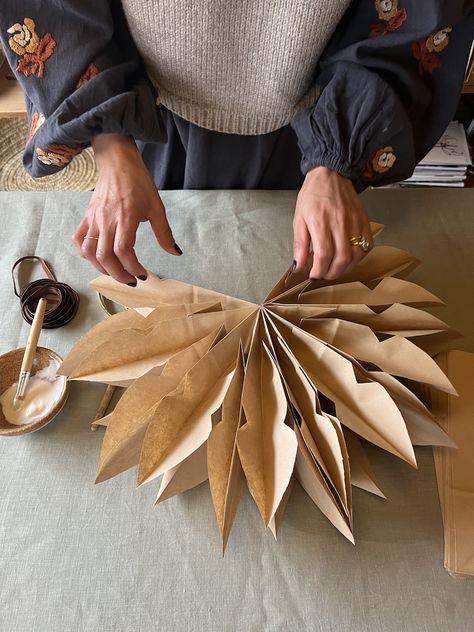 DIY: Simple and Sustainable Paper Bag Stars - Remodelista How To Make Brown Paper Bag Stars, Paper Bag Christmas Star, Brown Bag Snowflake Diy, Grocery Paper Bag Crafts, Paper Bag Ornaments Diy, Brown Paper Snowflakes, Paper Bag Stars Christmas, Paper Xmas Decorations Diy, Brown Bag Snowflake