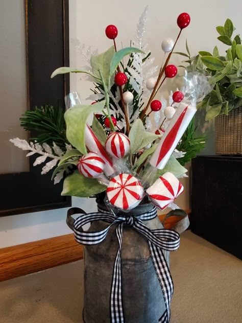 "Looking for decor for a small space or gift for a friend or coworker? This Farmhouse Centerpiece is loaded with high end pine, berries, florals, candy picks and accented with a simple black and white buffalo plaid bow. Florals are secured in floral foam and topped off with natural moss in the galvanized milk can. Perfect accent piece for your farmhouse decor, covered front porch area, bathroom, mantle or in a tiered tray. Centerpiece finished size is 10\"x6\". More Christmas items here: https:/ Christmas Decor Ideas For Small Bathroom, Milk Jug Christmas Decorations, Small Porch Christmas Decor Ideas, Farmhouse Kitchen Christmas Decor, Christmas Decor For Bathroom, Rustic Christmas Kitchen, Farmhouse Christmas Centerpiece, Pine Berries, Christmas Dining Table Decorations