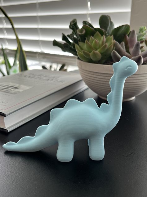 This little Dino is perfect to have as a friend at your house or as a gift to someone who loves dinosaurs. They are made to order and take about 4 hours to print each little Dino. It is roughly 5in x 1.5in x 4in. These are 3d printed using PLA material, (polylactic acid) which is a recyclable plastic derived from corn starch and sugar cane. 3d Printed Dinosaurs, 3 D Printing Projects, 3d Printing Aesthetic, Cute Things To 3d Print, 3d Printed Projects, Easy 3d Printing Ideas, 3d Printed Animals, Cool Things To 3d Print, 3 D Printer Projects